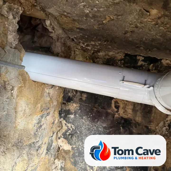 After: new white flue section fitted and supported through the stone void